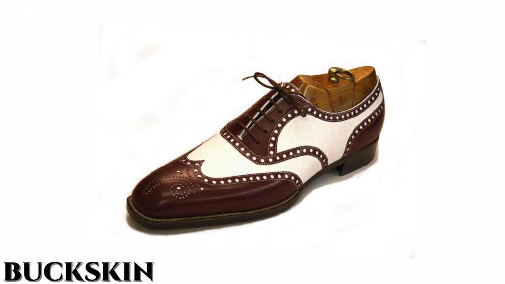 A full brogue spectator in brown and white color combination; the white portion is made of buckskin leather