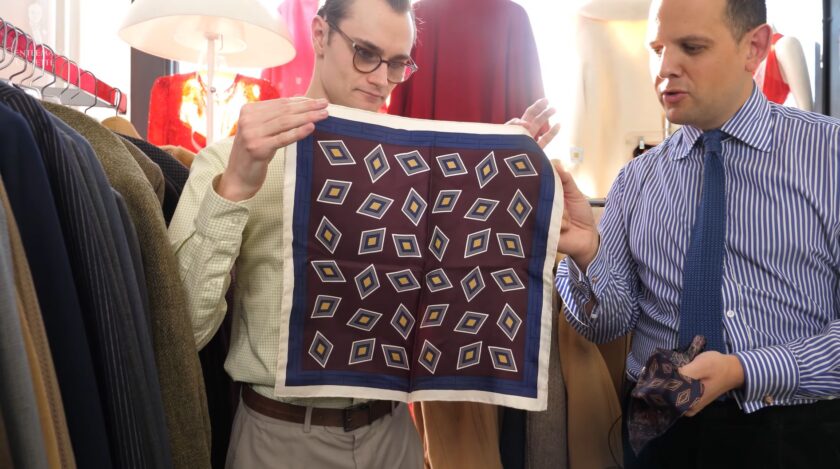 Preston holds up a vintage diamond-patterned pocket square with white edges