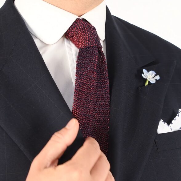 You may wear a knit tie to elevate a traditional business suit ensemble