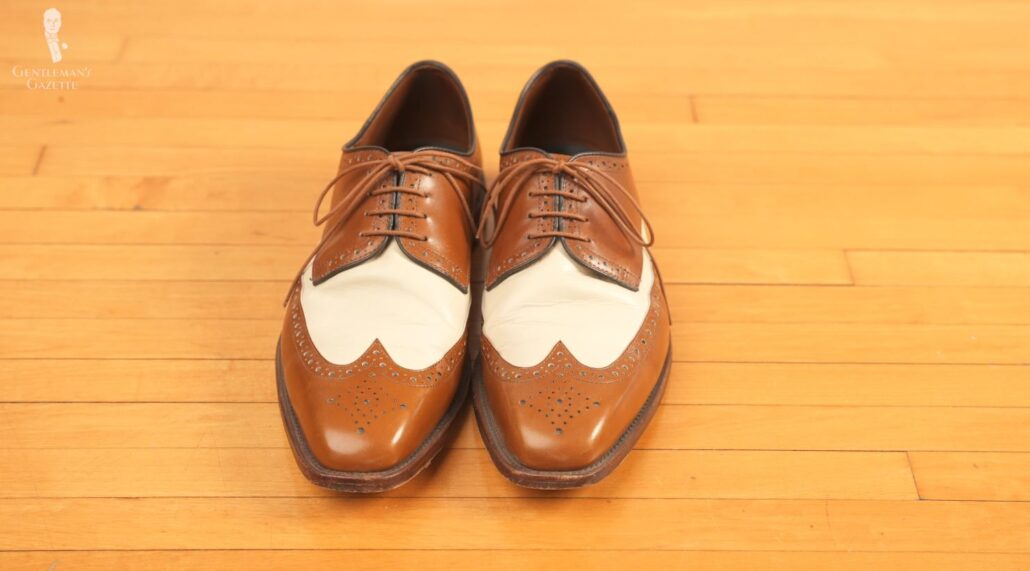 A pair of spectator shoes with a leather construction