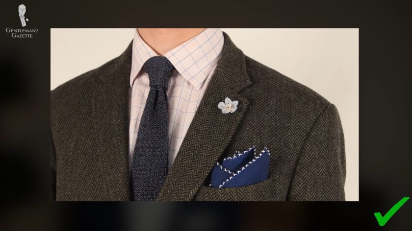 A gray herringbone Harris tweed sport coat with blue accessories from Fort Belvedere