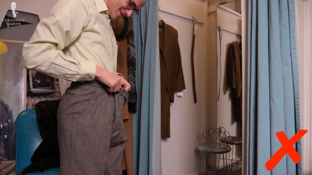 Preston tries on a pair of trousers that are too large