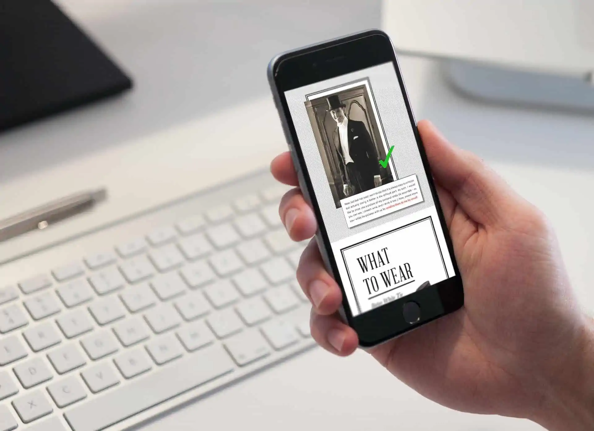 A photograph of a phone depicting the white tie guide ebook