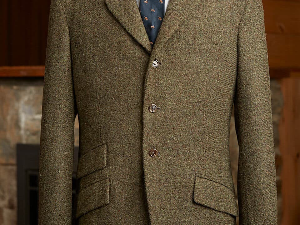 Horizontal ticket pockets compared to angled ticket pockets on a three-button tweed  hacking jacket.