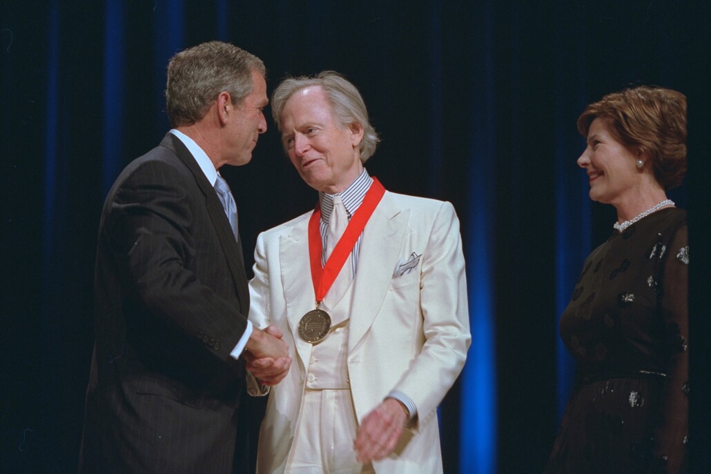Journalist Tom Wolfe, in his signature white suit, receives the Arts and Humanities Medal from President George W. Bush