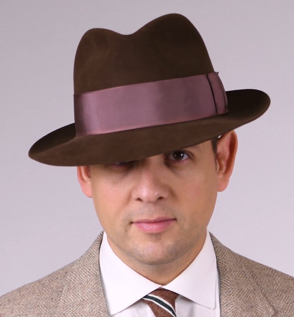 Raphael wearing a brown Fedora hat with confidence