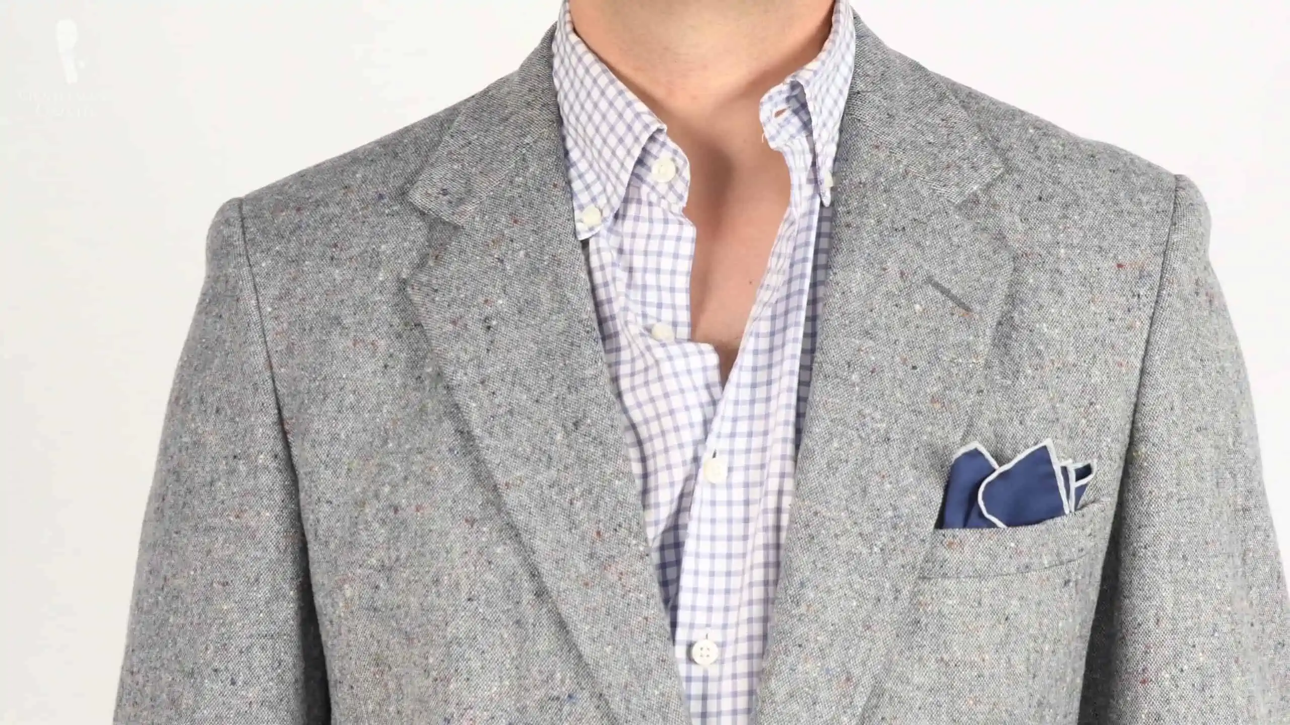 A dark blue pocket square with gray suit