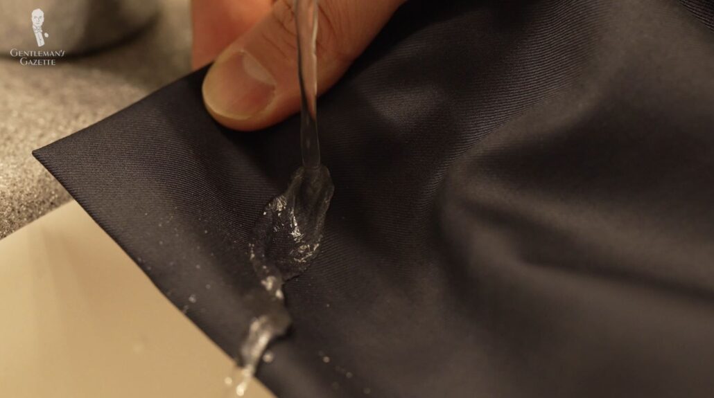 Raphael tests the water-repellent Aquaspider 160s material of his Isaia suit jacket