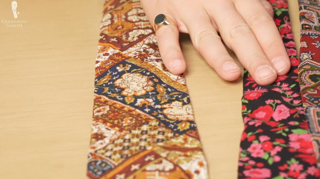 Examples are shown here: a brown and orange tie, and a floral tie