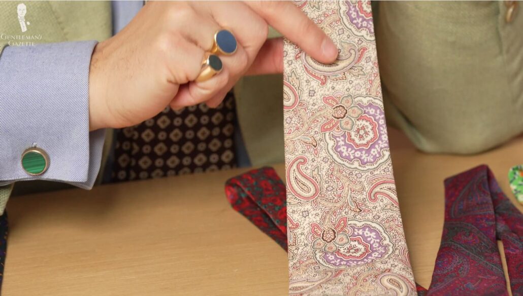 Raphael shows an unusual paisley tie with an off-white base