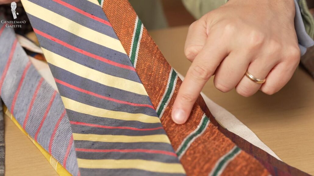 Raphael points out the difference of two shantung silk ties (Pictured: Shantung Striped Bronze Orange, Green, and Cream Silk Tie from Fort Belvedere)