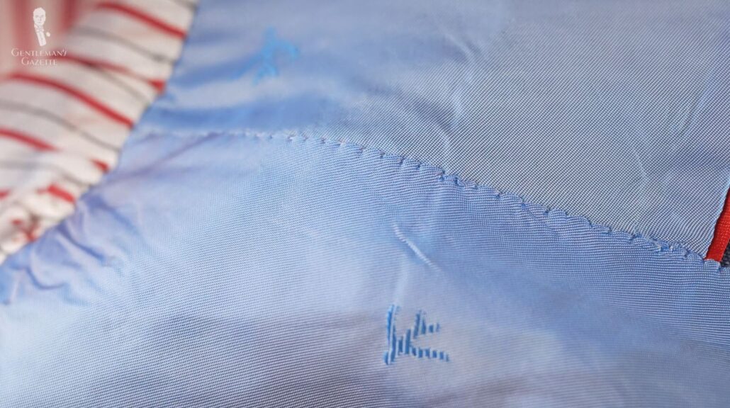 Irregular stitching on an Isaia jacket's sleeve lining