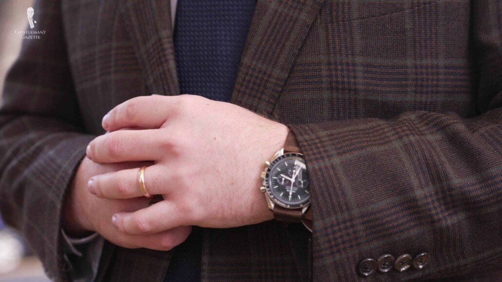 Nathan successfuly pairs a gold wedding band with a silver-toned watch.