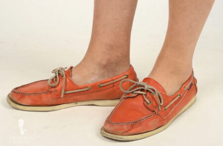 A pair of orange boat shoes
