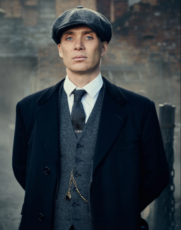 Peaky Blinders character Tommy Shelby wears a peaked cap