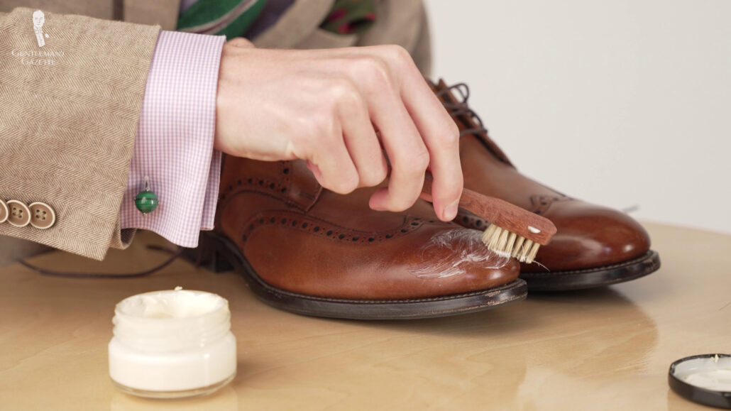 Preston polishing his dress shoes