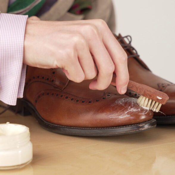 Preston polishing his dress shoes