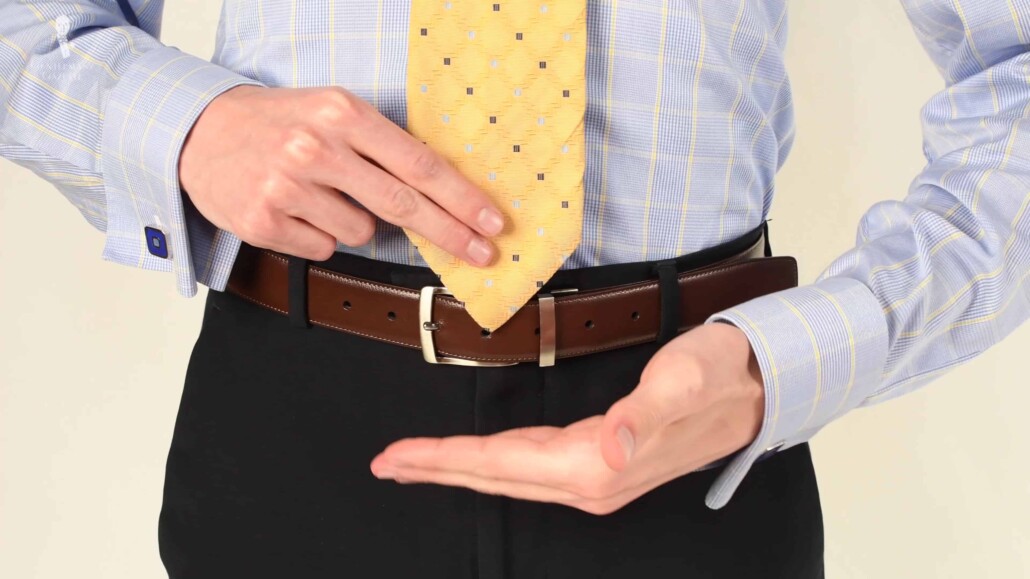 The standard "correct" length for a modern necktie: in the center of the trouser waistband.