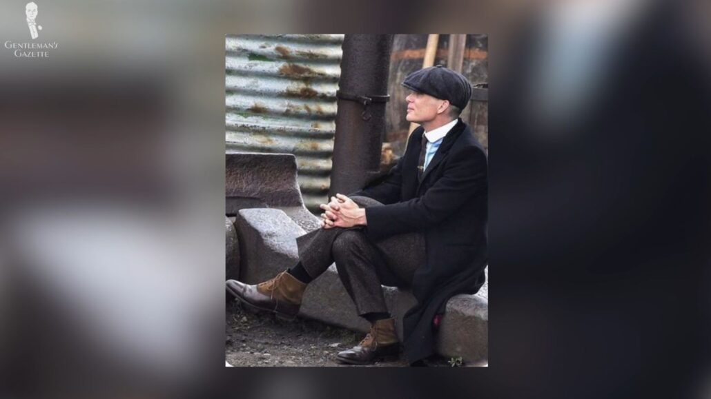 A behind-the-scenes photo of Tommy Shelby wearing a pair of balmoral boots [Image Credit: @Peaky_Duchess]