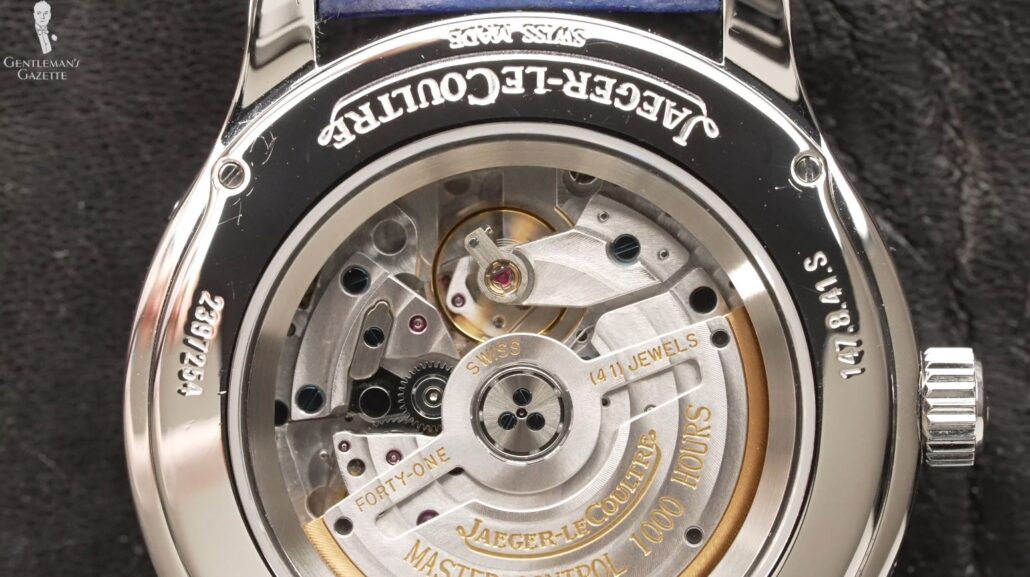 Cogs, wheels, and springs at the back of a JLC watch