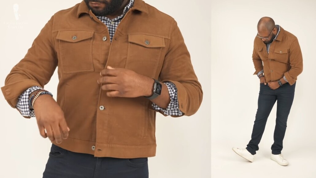 Kyle is wearing a brown denim-jacket inspired moleskin jacket with blue and white checked casual shirt.