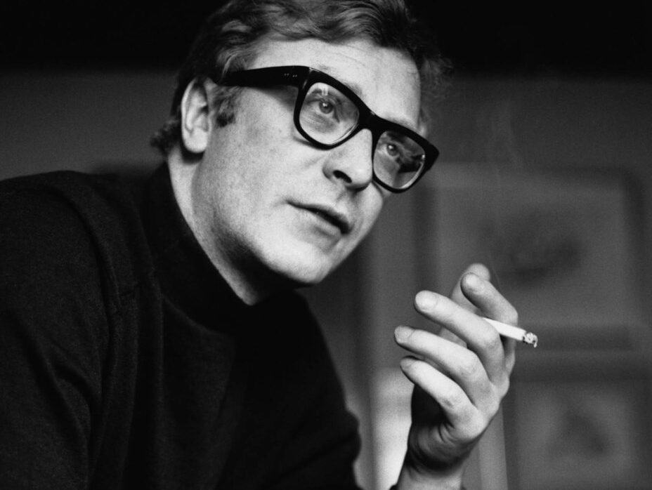 Michael Caine wearing statement rectangular glasses in the 60s