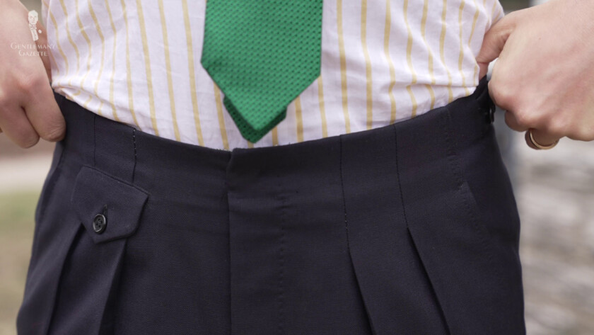 The trousers have outward-facing pleats and don't come with a waistband.