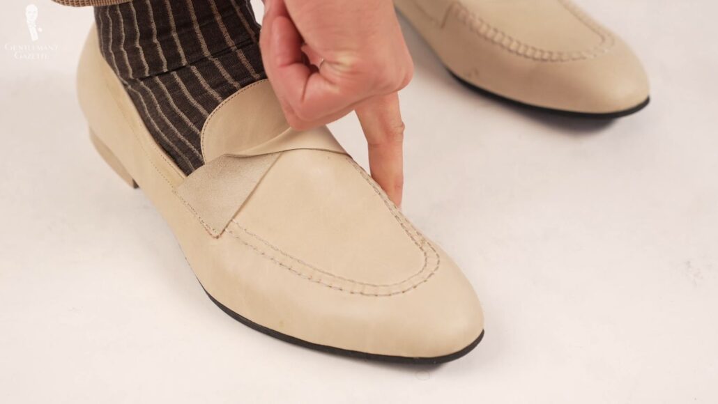 Raphael shows how snug a pair of loafers should fit which requires a different last from an Oxford or a derby (Pictured: Shadow Stripe Ribbed Socks Dark Brown and Beige from Fort Belvedere)