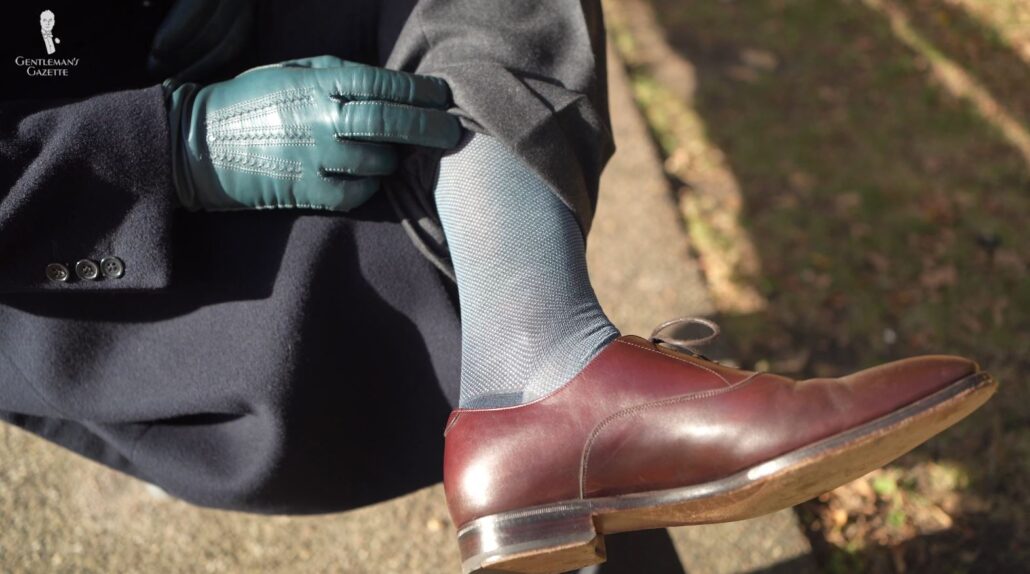 The combination of grey blue  and prussian blue on the socks adds a touch of color to a rather muted outfit