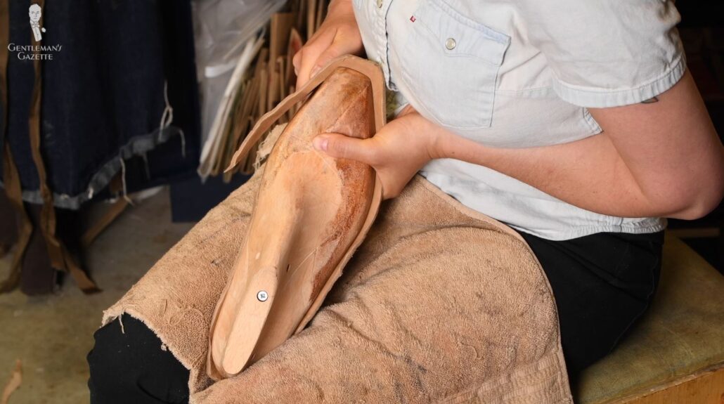 Amara carves the insoles for the shoe to be more comfortable