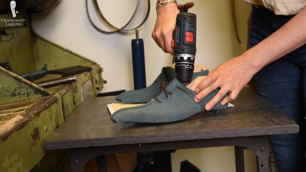 Amara makes adjustments to the second trial shoes based on Raphael's feedback
