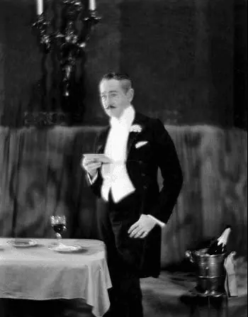 Adolphe Menjou wears a formal ascot with his morning wear in this scene from A Woman of Paris (1923). [Image Credit: United Artists]