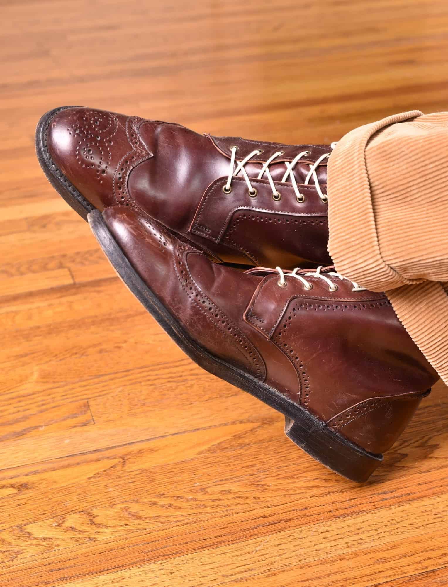 Cordovan boots with pink laces and tan corduroy trousers