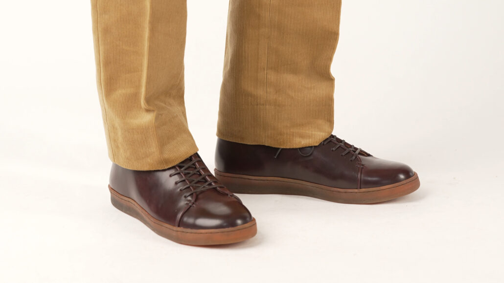 Preston's classic burgundy color Cordovan dress sneakers are paired here with corduroy trousers in a rich tobacco color.