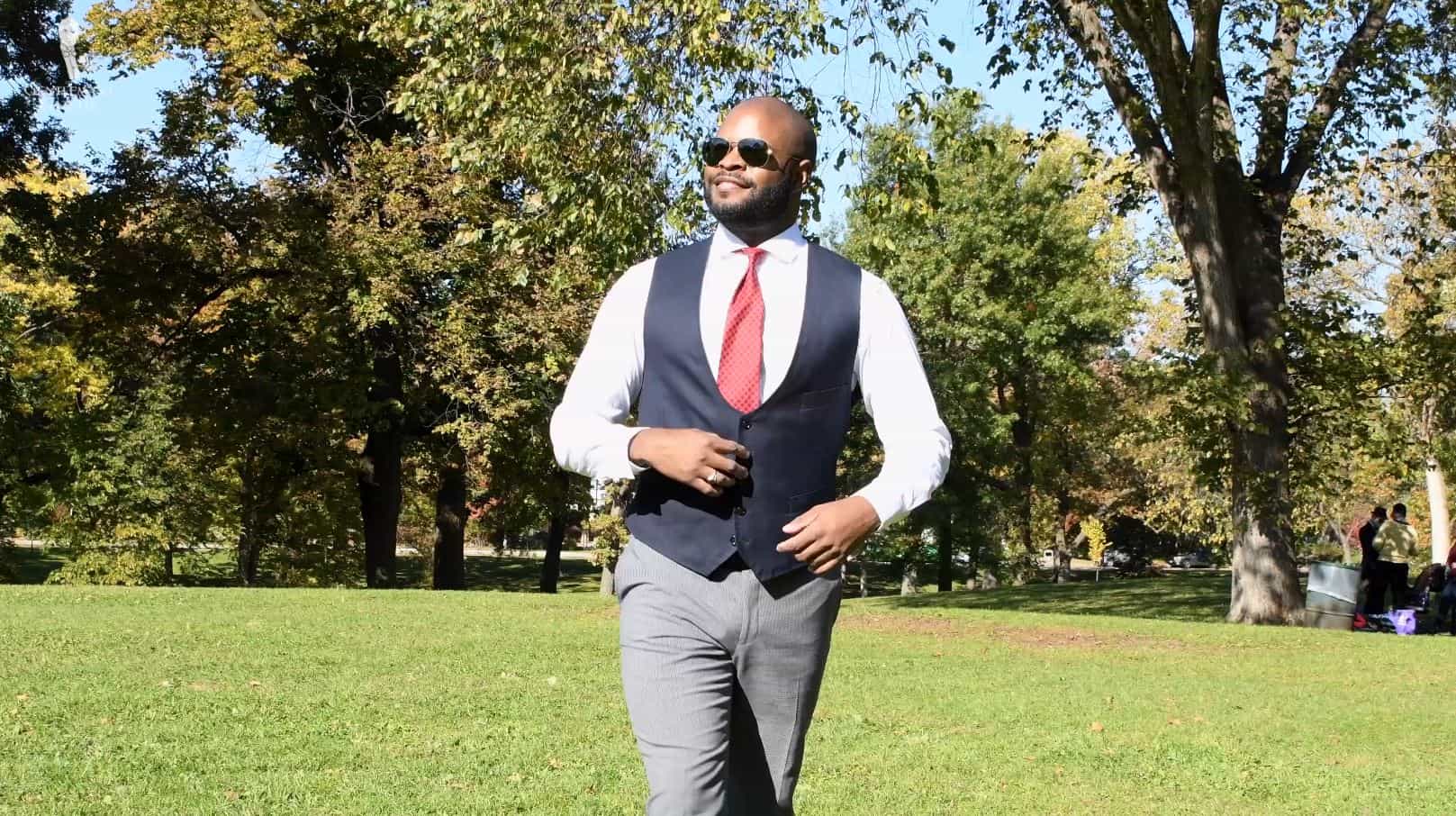 Kyle wears his sunglasses outside to shield his eyes from the sun (Pictured: Madder Silk Tie in Orange Red with Green Macclesfield Neats from Fort Belvedere)