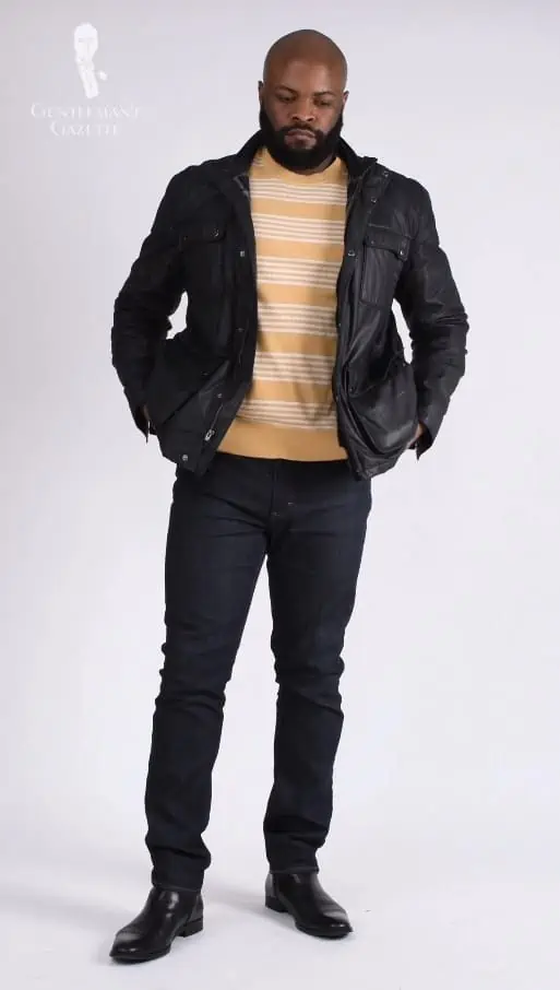 Kyle wearing a striped-yellow shirt, and a black leather jacket paired with jeans.