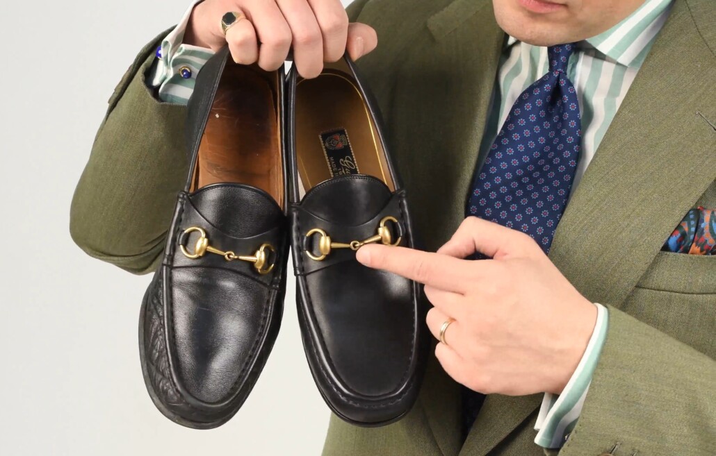 Raphael holds a pair of black Gucci 1953 Horsebit leather loafers
