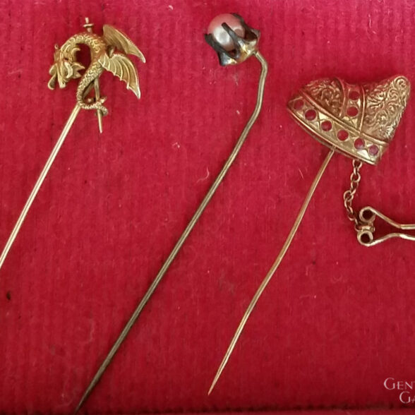 A collection of gold stick pins