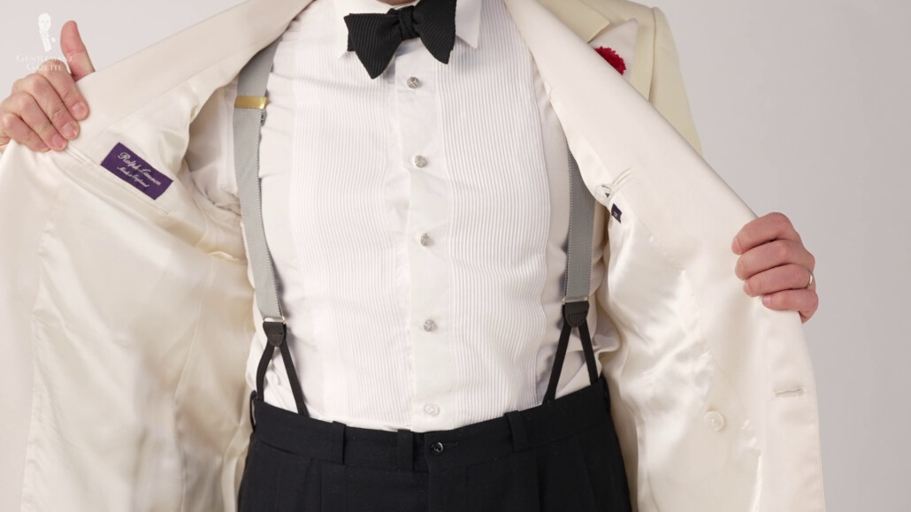 Suspenders held the trousers in place by suspending them from the shoulders and were attached to the waistband by ties or buttons.