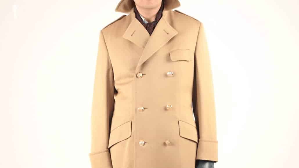 This Heinz Becker overcoat in tan color is complemented by further earth tones in the dark green gloves and burgundy scarf .