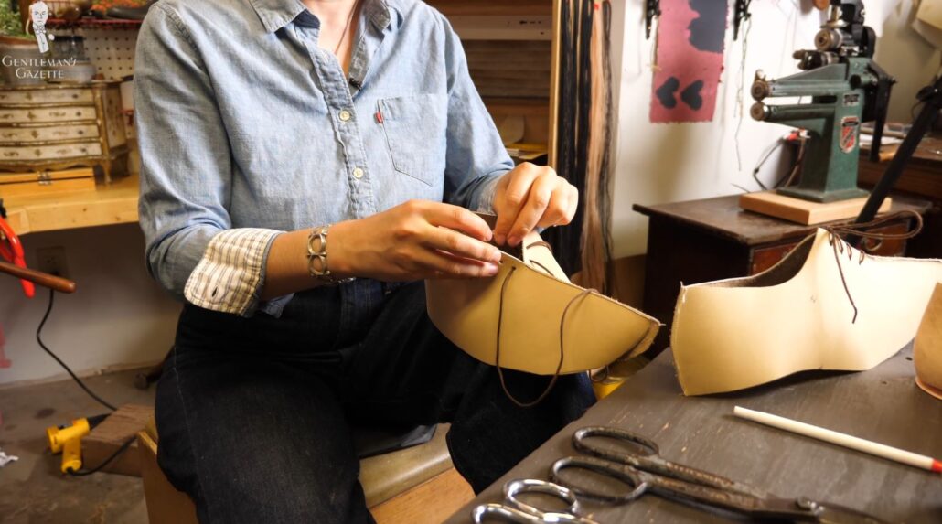 St. Paul, Minnesota shoemaker, Amara Hark Weber puts temporary shoelaces on an unfinished trial shoe