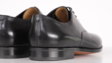 Black John Lobb Oxford shoes with a slim sole and heel