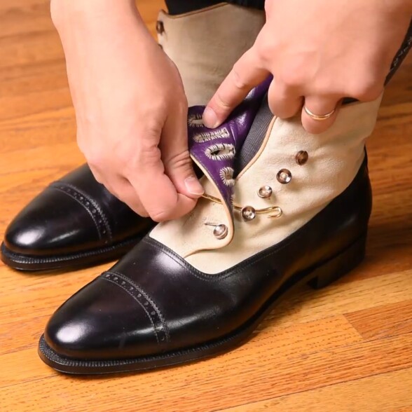Fastening a pair of button boots with a button hook