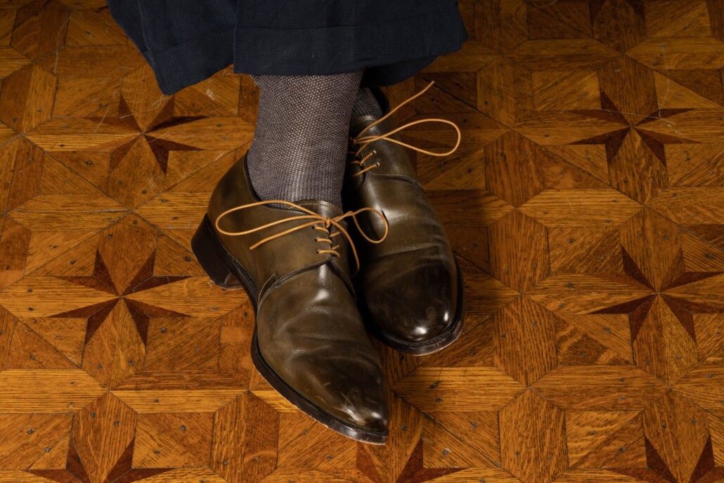 Olive green Derby shoes with an aged patina and ochre laces