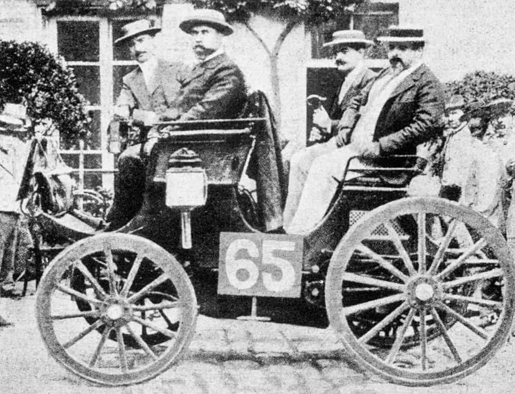 Photograph of four men in a primitive car from the 1890s