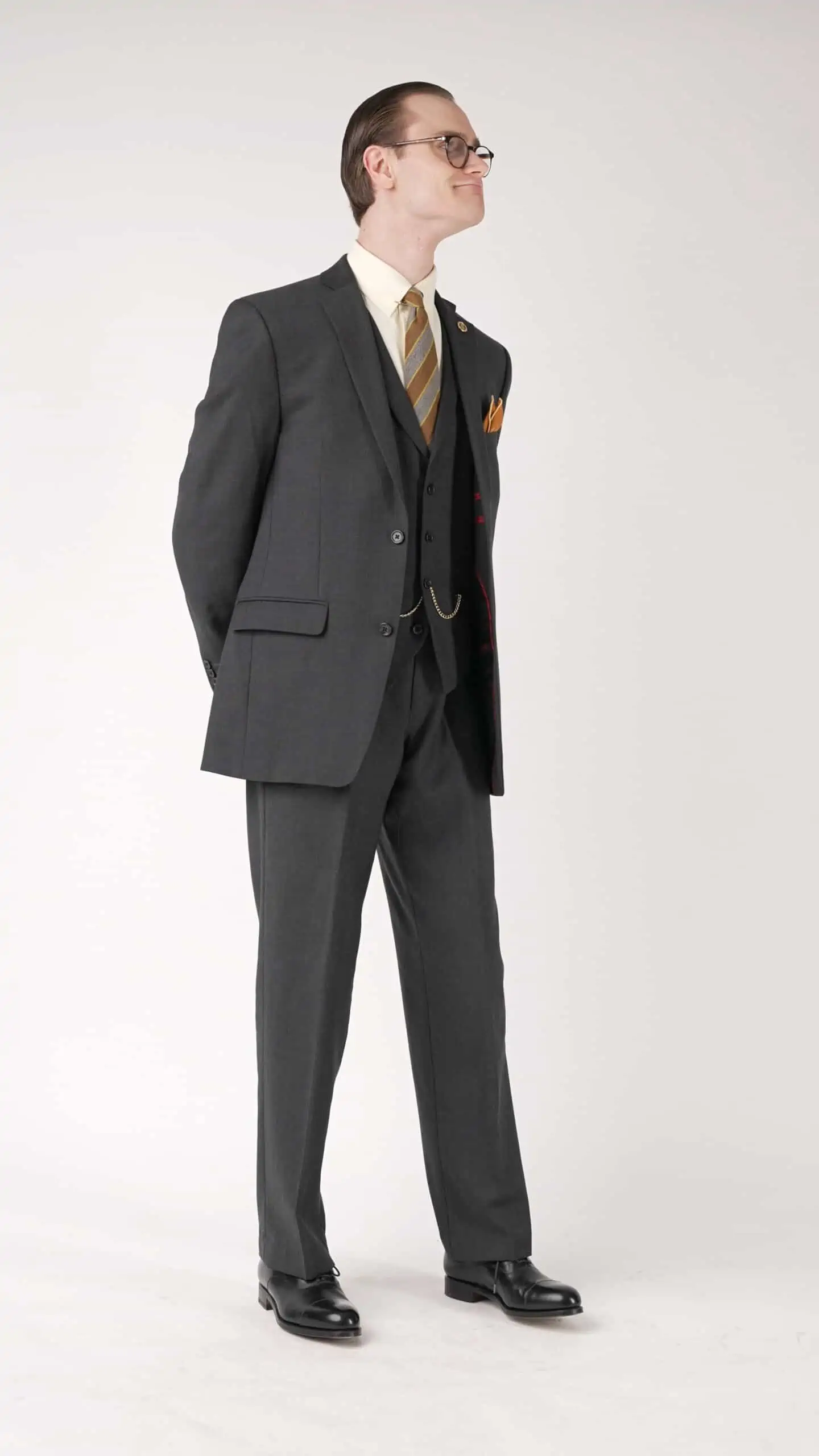 Preston showcases a charcoal three piece suit with a classic pair of black cap toe Oxfords