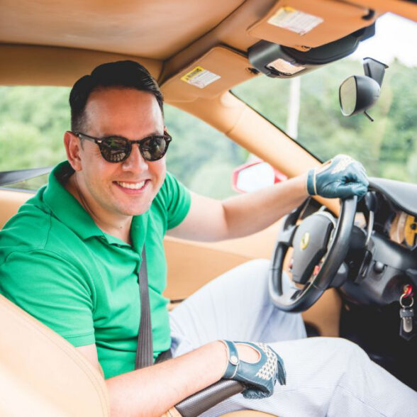Raphael is ready to drive a luxury sportscar in his sunglasses, green polo shirt, seersucker trousers, and green Fort Belvedere driving gloves