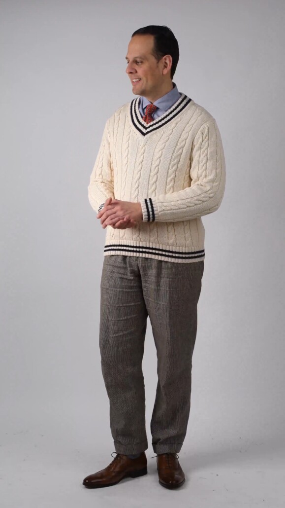 Raphael opts for a cricket sweater and a pair of brown wingtip oxfords in a semi casual outfit