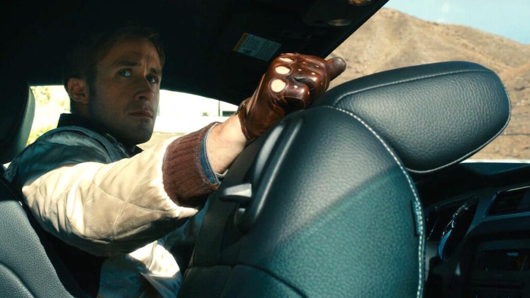 Ryan Gosling wearing driving gloves in Drive (2011).