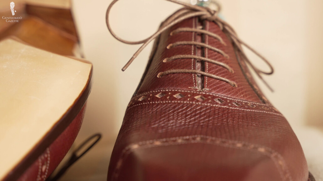 The Adelaide design has shoelace holes that progressively got slimmer towards the top.